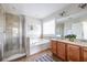 Bathroom showcasing a dual sink vanity, tub, and glass enclosed shower at 134 Turman Se Ave, Atlanta, GA 30315