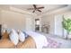 Relaxing main bedroom featuring a ceiling fan, tray ceiling, and neutral tones at 134 Turman Se Ave, Atlanta, GA 30315