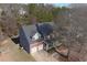 Overhead view of a charming two-story home, showcasing the roof, landscaping, and surrounding trees at 2124 Mitford Ct, Dacula, GA 30019