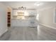 Well-lit finished basement kitchen area with white cabinetry and modern appliances at 2124 Mitford Ct, Dacula, GA 30019