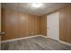 A versatile basement space featuring wood-paneled walls and durable luxury vinyl flooring at 2124 Mitford Ct, Dacula, GA 30019