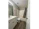 Bathroom with a single sink vanity, mirror, toilet, and shower with bathtub at 2124 Mitford Ct, Dacula, GA 30019