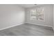 Light-filled bedroom with wood floors and a window for natural light at 2124 Mitford Ct, Dacula, GA 30019