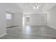 Spacious, bright bedroom with gray wood floors and a ceiling fan at 2124 Mitford Ct, Dacula, GA 30019