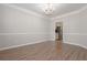 Formal dining room with chandelier, hardwood floors, and access to the kitchen at 2124 Mitford Ct, Dacula, GA 30019