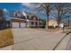 Charming two-story brick home with a front porch and a well-manicured lawn at 2124 Mitford Ct, Dacula, GA 30019