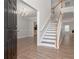 Welcoming foyer with hardwood floors, staircase, and elegant chandelier at 2124 Mitford Ct, Dacula, GA 30019