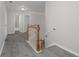 Upstairs hallway with views of the staircase, with fresh paint and hard wood floors at 2124 Mitford Ct, Dacula, GA 30019