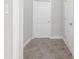 Hallway with tile flooring and white doors at 2124 Mitford Ct, Dacula, GA 30019