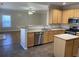 Bright kitchen with stainless steel appliances and an adjacent living room at 2124 Mitford Ct, Dacula, GA 30019