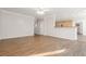 Spacious open-concept living room flowing into the kitchen with wood floors and neutral paint at 2124 Mitford Ct, Dacula, GA 30019