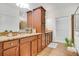 Well-lit bathroom with granite countertops, wood cabinets, and modern fixtures at 2752 Middlecreek Way, Cumming, GA 30041