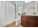 Bathroom featuring a shower with a curtain, shuttered window, and single sink at 2752 Middlecreek Way, Cumming, GA 30041