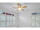 Bright bedroom with ceiling fan, plantation shutters, and clerestory windows at 2752 Middlecreek Way, Cumming, GA 30041