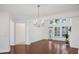 Bright dining room with hardwood floors, a chandelier, and lots of natural light from the adjacent windows at 2752 Middlecreek Way, Cumming, GA 30041