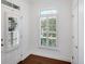 Bright entryway with hardwood floors, white trim, and a window for natural light at 2752 Middlecreek Way, Cumming, GA 30041