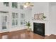 Light-filled living room with plantation shutters, a fireplace, and dark hardwood flooring at 2752 Middlecreek Way, Cumming, GA 30041