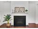 Elegant living room with dark hardwood floors, a decorative fireplace, and neutral decor at 2752 Middlecreek Way, Cumming, GA 30041