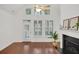 Bright living room with a fireplace, large windows, and wood floors, with a view of the kitchen at 2752 Middlecreek Way, Cumming, GA 30041