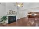 Open-concept living area featuring a fireplace, dark hardwood floors, and a view into the kitchen at 2752 Middlecreek Way, Cumming, GA 30041