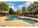 Resort-style pool area featuring a large in-ground pool, lounge chairs, and mature landscaping at 2752 Middlecreek Way, Cumming, GA 30041