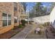 View of the backyard showcasing a walkway, patio and lots of trees for privacy at 891 Legacy Woods Dr, Norcross, GA 30093