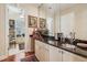 Bar area with granite countertops, decorative backsplash, and cabinetry at 891 Legacy Woods Dr, Norcross, GA 30093