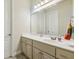 Bright bathroom showcasing a long vanity with neutral cabinets and a large mirror at 891 Legacy Woods Dr, Norcross, GA 30093