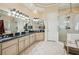 Bathroom featuring double sink vanity, marble counters and floors, and glass walk-in shower at 891 Legacy Woods Dr, Norcross, GA 30093