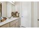 Bright bathroom featuring a sink with neutral cabinets and decorative floral accents at 891 Legacy Woods Dr, Norcross, GA 30093