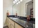 Stylish bathroom featuring a sink with granite countertops and a large mirror at 891 Legacy Woods Dr, Norcross, GA 30093