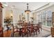 Formal dining room with hardwood floors, elegant chandelier, and large windows at 891 Legacy Woods Dr, Norcross, GA 30093