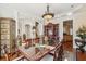 Formal dining room with hardwood floors, elegant chandelier, and views to other living areas at 891 Legacy Woods Dr, Norcross, GA 30093