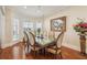 Charming dining room with hardwood floors, natural light, and a stylish table setting at 891 Legacy Woods Dr, Norcross, GA 30093