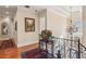 Hallway with chandelier and decorative bannister overlooking foyer at 891 Legacy Woods Dr, Norcross, GA 30093