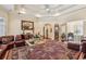 Spacious living room with a tray ceiling, wet bar, and decorative fireplace at 891 Legacy Woods Dr, Norcross, GA 30093