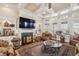 Cozy living room featuring fireplace, custom built-ins, and a wall of windows for natural light at 891 Legacy Woods Dr, Norcross, GA 30093