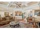 Elegant living room featuring coffered ceilings, hardwood floors, and refined furnishings at 891 Legacy Woods Dr, Norcross, GA 30093