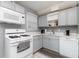 Bright kitchen featuring white appliances, grey cabinets, and white countertops at 329 Cabaret Ct # 329, Marietta, GA 30064