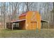 Exterior of a barn with red roof and 'Railroad Crossing' sign on the side. Wooden construction at 4009 Highway 138 Sw, Stockbridge, GA 30281