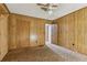 Bedroom featuring wood paneling, neutral carpeting, closet, and ensuite at 4009 Highway 138 Sw, Stockbridge, GA 30281