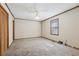 A spacious bedroom with plush carpet, ceiling fan, and a window allowing natural light at 4009 Highway 138 Sw, Stockbridge, GA 30281