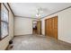 Bedroom boasts carpeting, a window with blinds, and a closet with wooden doors at 4009 Highway 138 Sw, Stockbridge, GA 30281