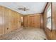 Bedroom with wood paneled walls, neutral carpet, ceiling fan and closet at 4009 Highway 138 Sw, Stockbridge, GA 30281