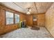 Bonus room with natural wood walls, backyard access, and ceiling fan at 4009 Highway 138 Sw, Stockbridge, GA 30281