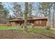 Charming single-story home featuring wood siding, a red metal roof, and a cozy front porch at 4009 Highway 138 Sw, Stockbridge, GA 30281