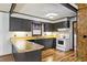 A modern kitchen with black cabinets, wooden countertops, and white appliances at 4009 Highway 138 Sw, Stockbridge, GA 30281