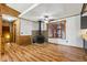 Living area with hardwood floors, wood-burning stove, stone feature, and large windows allowing for lots of light at 4009 Highway 138 Sw, Stockbridge, GA 30281