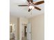 Bedroom featuring a lighted ceiling fan, carpet, and open doorway to the en-suite bathroom at 1734 Doonbeg Ct, Kennesaw, GA 30152