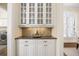 Convenient butler's pantry featuring granite countertop, storage cabinets, and a laundry area nearby at 1734 Doonbeg Ct, Kennesaw, GA 30152